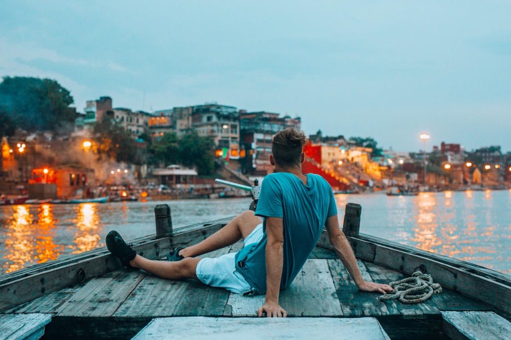 A Man Sitting on the Wooden Boat