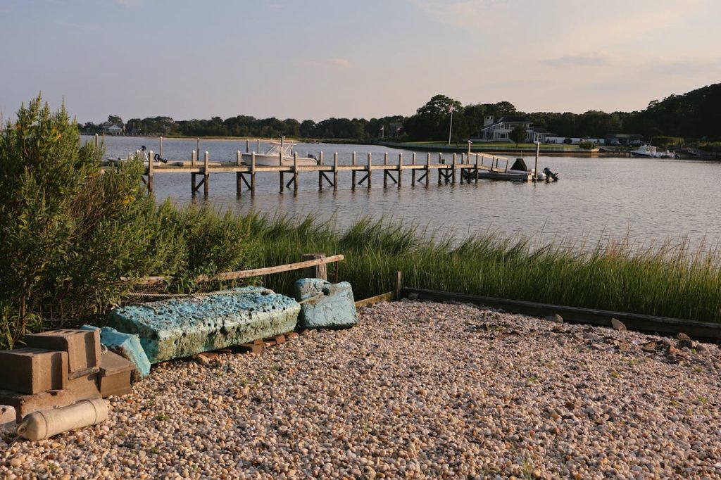 A bench is sitting on the shore of Hampton Bays, NY, United States