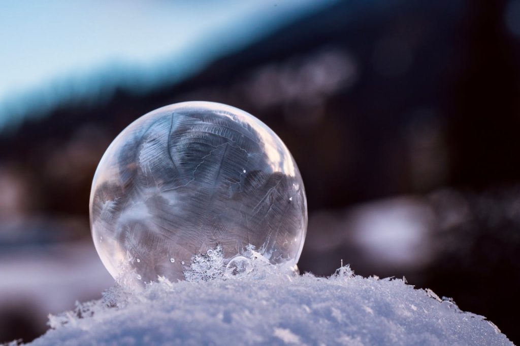 Frosty Bubble Resting on Snow in Winter