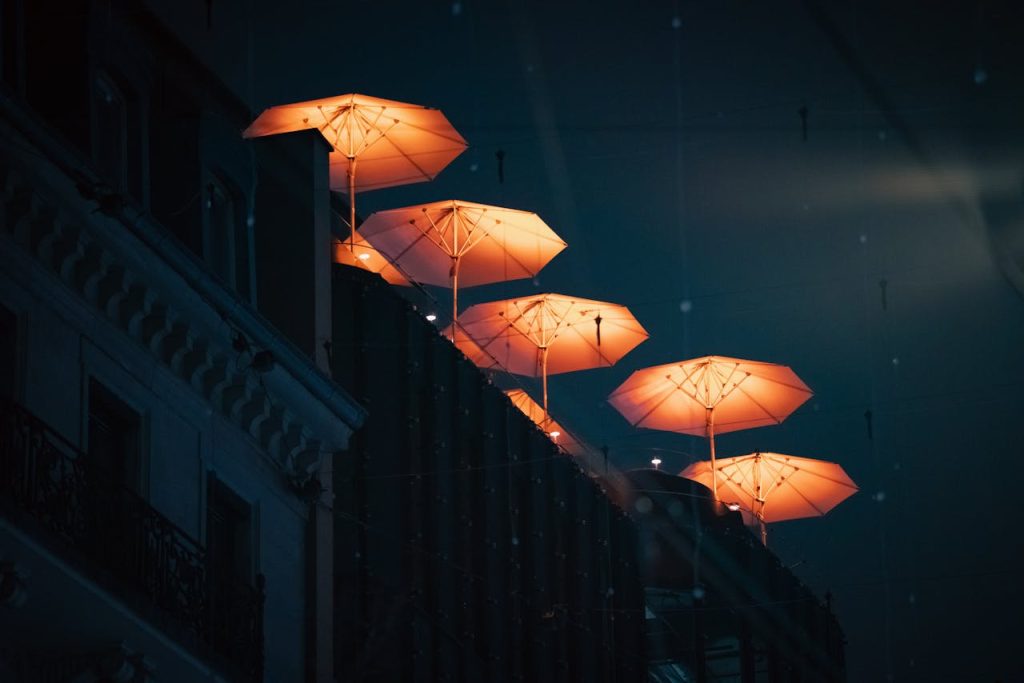 Illuminated Umbrellas at Night on Rooftop