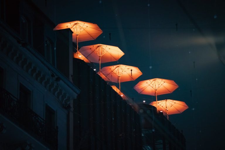 Illuminated Umbrellas at Night on Rooftop
