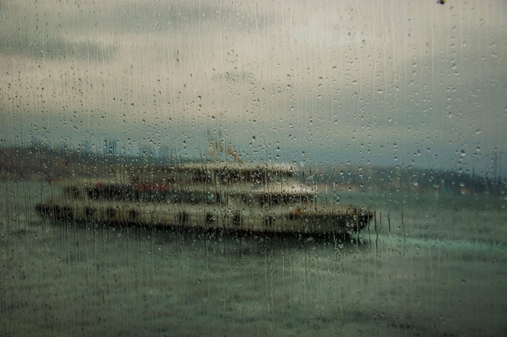 12 Cruise Ship Excursions That Strand Passengers in Chaos – Her Life Adventures Blurred View of Boat on Sea on a Rainy Day Through a Window