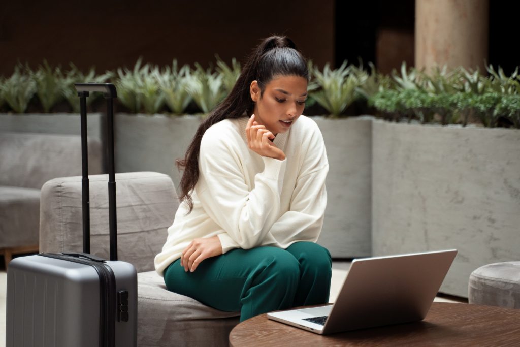 woman checking hotel prices on laptop