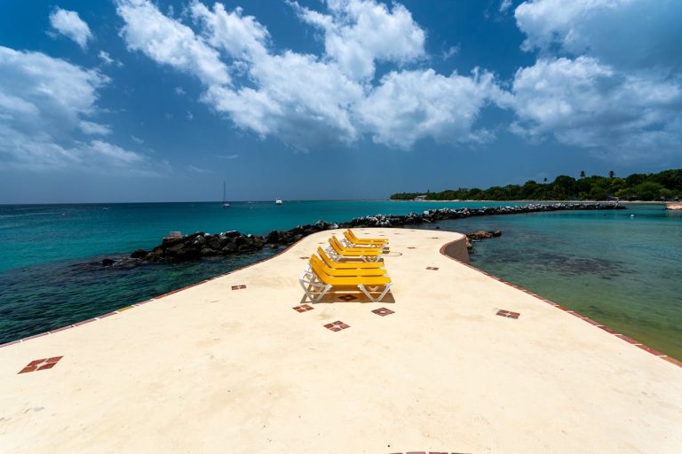 Scenic Beachfront with Yellow Chairs in Tobago